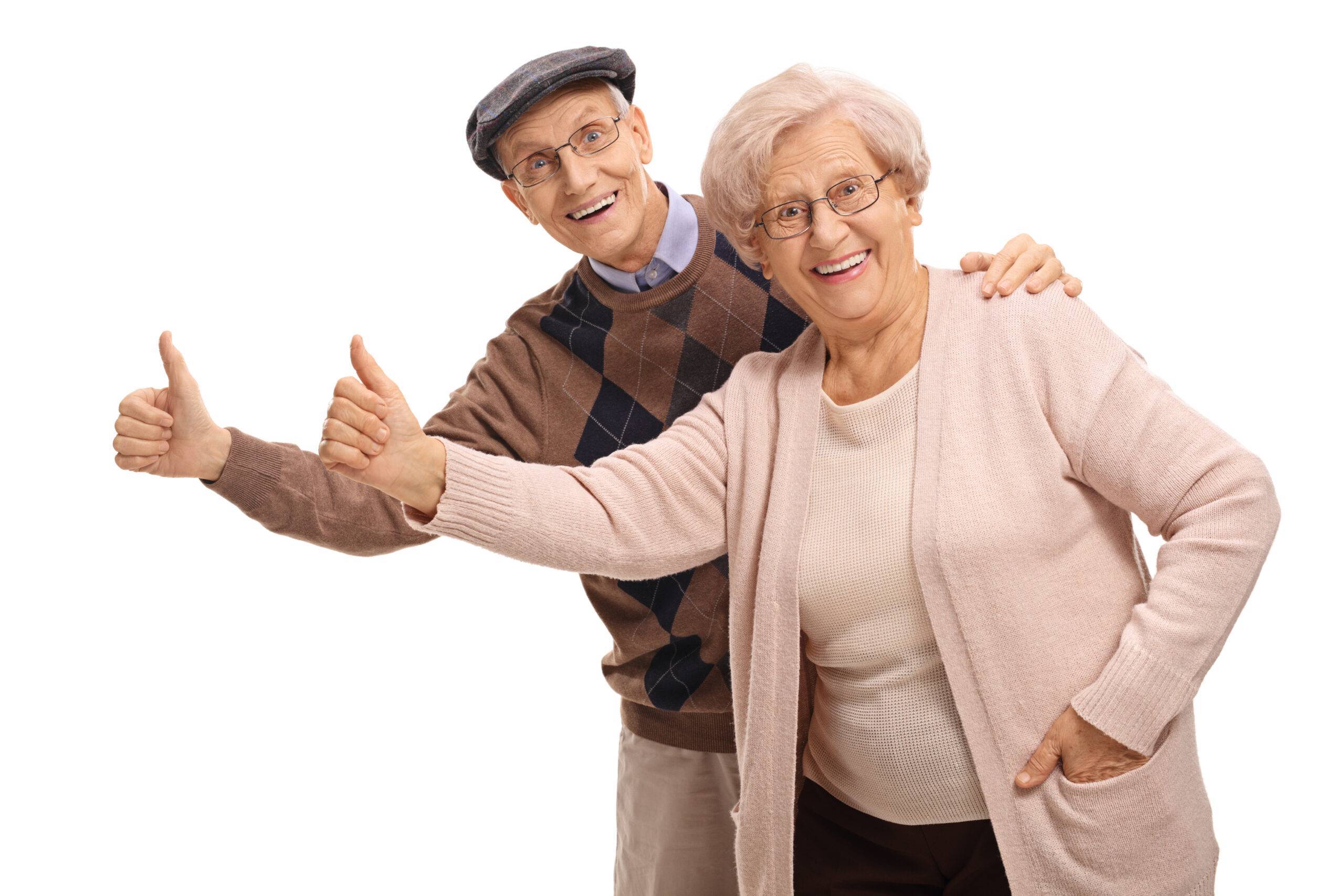 Cheerful seniors holding their thumbs up isolated on white background